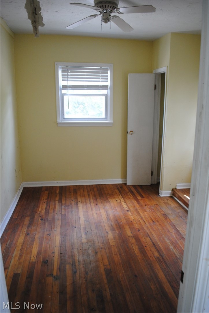 16110 Rockside Road Maple Heights, OH 44137 - Photo 15 of 17 Room featuring wood-finish flooring, a ceiling fan with light, and a window with blinds