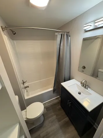 a bathroom with a sink mirror vanity and toilet