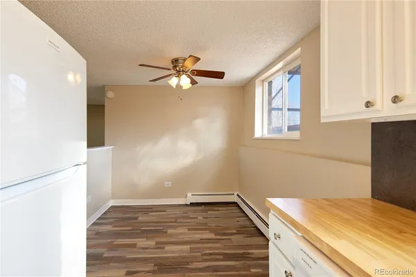 a view of a big room with wooden floor and windows