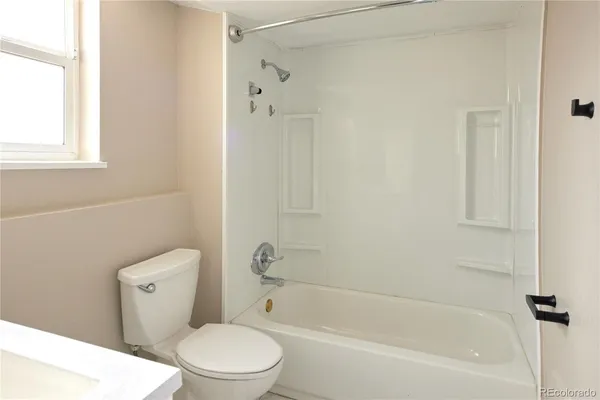 a bathroom with a sink a mirror and a window