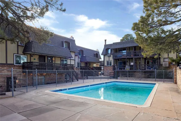 a view of a house with a wooden fence