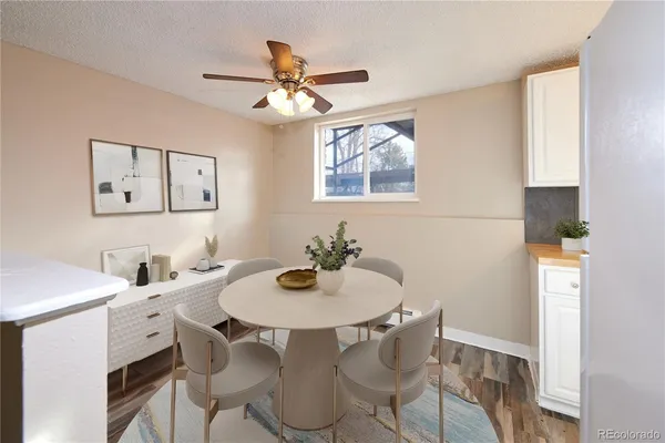 a view of a room with wooden floor and ceiling fan