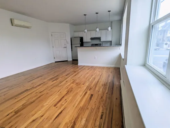 a view of a kitchen with a sink and wooden floor