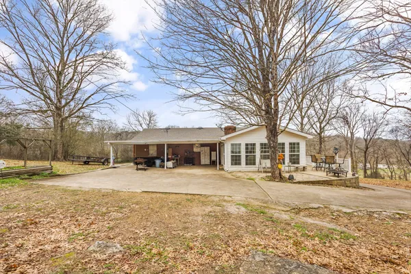 a front view of a house with a yard and trees