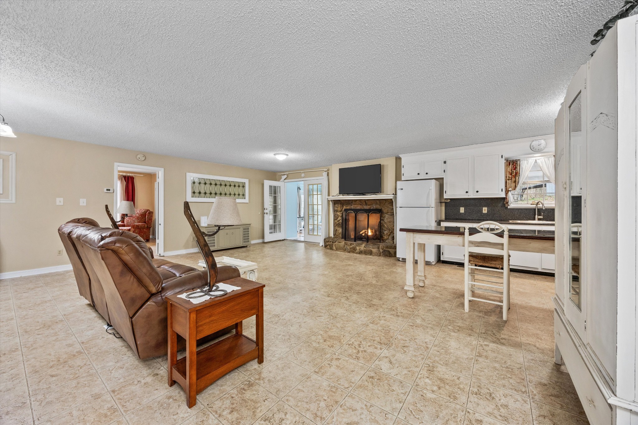 631 Holt Hollow Road Prospect, TN 38477 - Photo 7 of 41 a living room with furniture a fireplace and a flat screen tv