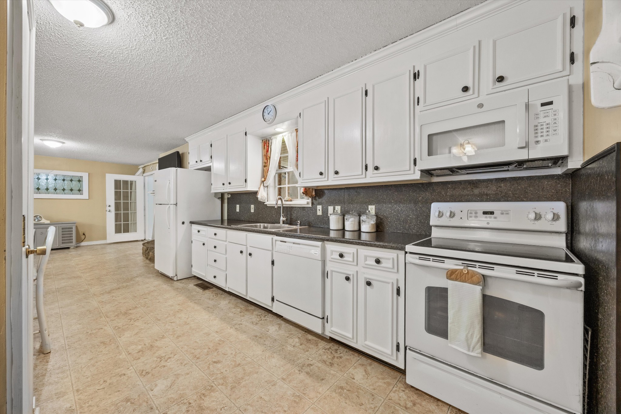631 Holt Hollow Road Prospect, TN 38477 - Photo 8 of 41 a kitchen with granite countertop white cabinets and white appliances
