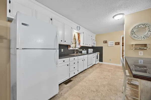 a kitchen with stainless steel appliances a refrigerator sink and cabinets