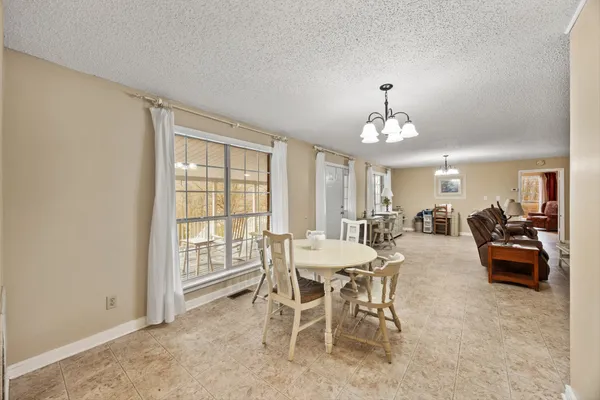 a view of a dining room with furniture and chandelier