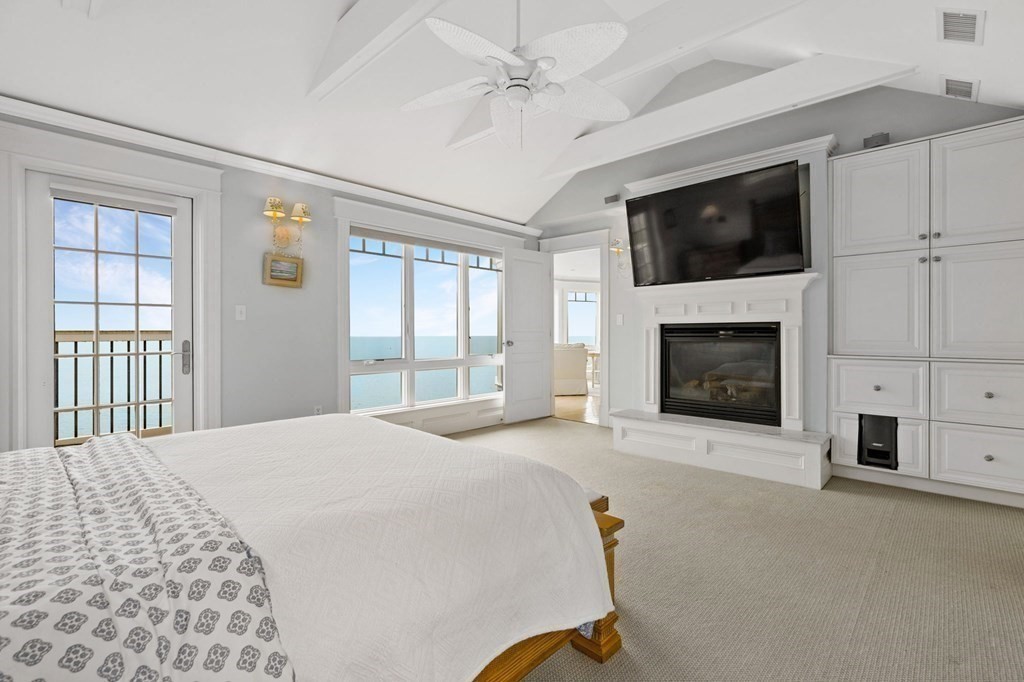 79 Gilson Road Scituate, MA 02066 - Photo 26 of 42 a spacious bedroom with a bed and a fireplace