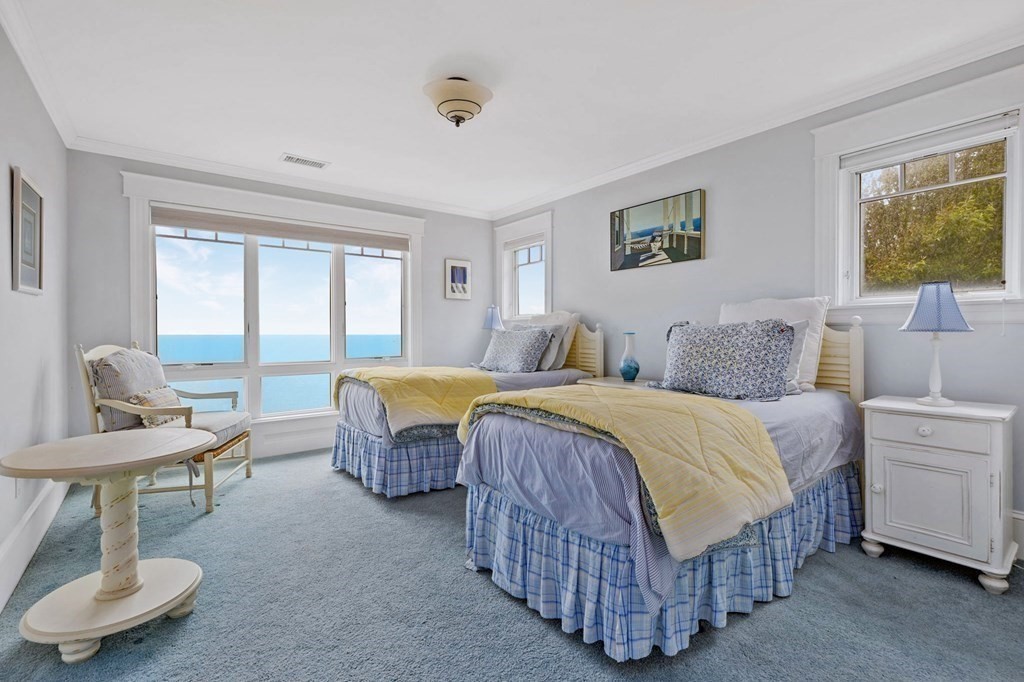 79 Gilson Road Scituate, MA 02066 - Photo 27 of 42 a spacious bedroom with a bed and a table