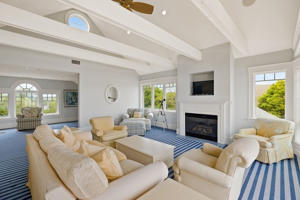 79 Gilson Road Scituate, MA 02066 - Photo 29 of 42 a living room with furniture a fireplace and a large window