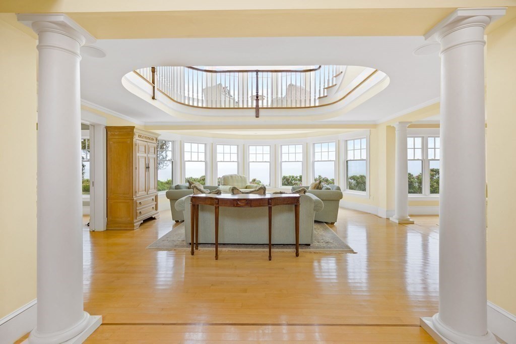 79 Gilson Road Scituate, MA 02066 - Photo 5 of 42 a dining hall with couches a dining table and chairs with wooden floor
