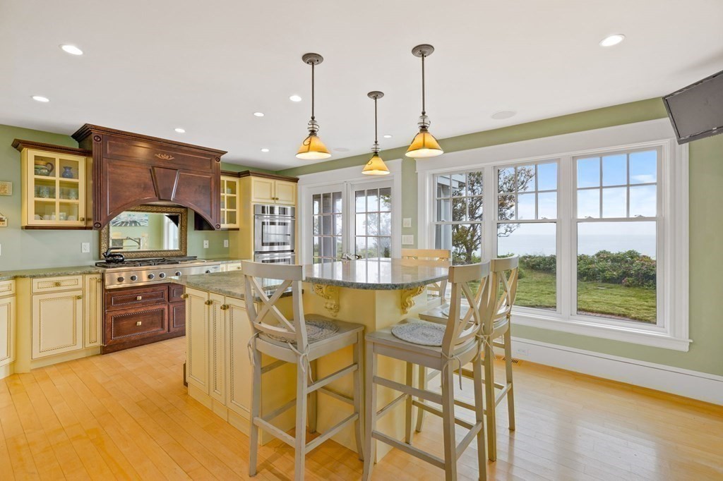 79 Gilson Road Scituate, MA 02066 - Photo 8 of 42 a kitchen with stainless steel appliances granite countertop a stove and cabinets with wooden floor
