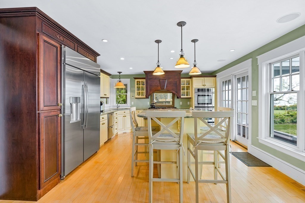 79 Gilson Road Scituate, MA 02066 - Photo 9 of 42 a kitchen with stainless steel appliances kitchen island granite countertop a refrigerator and microwave