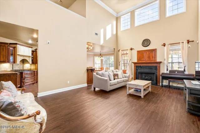 a living room with furniture a fireplace and a flat screen tv