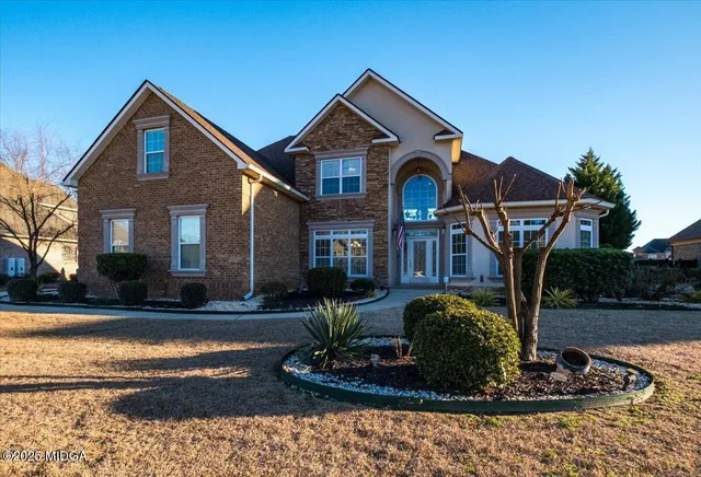 a front view of a house with garden