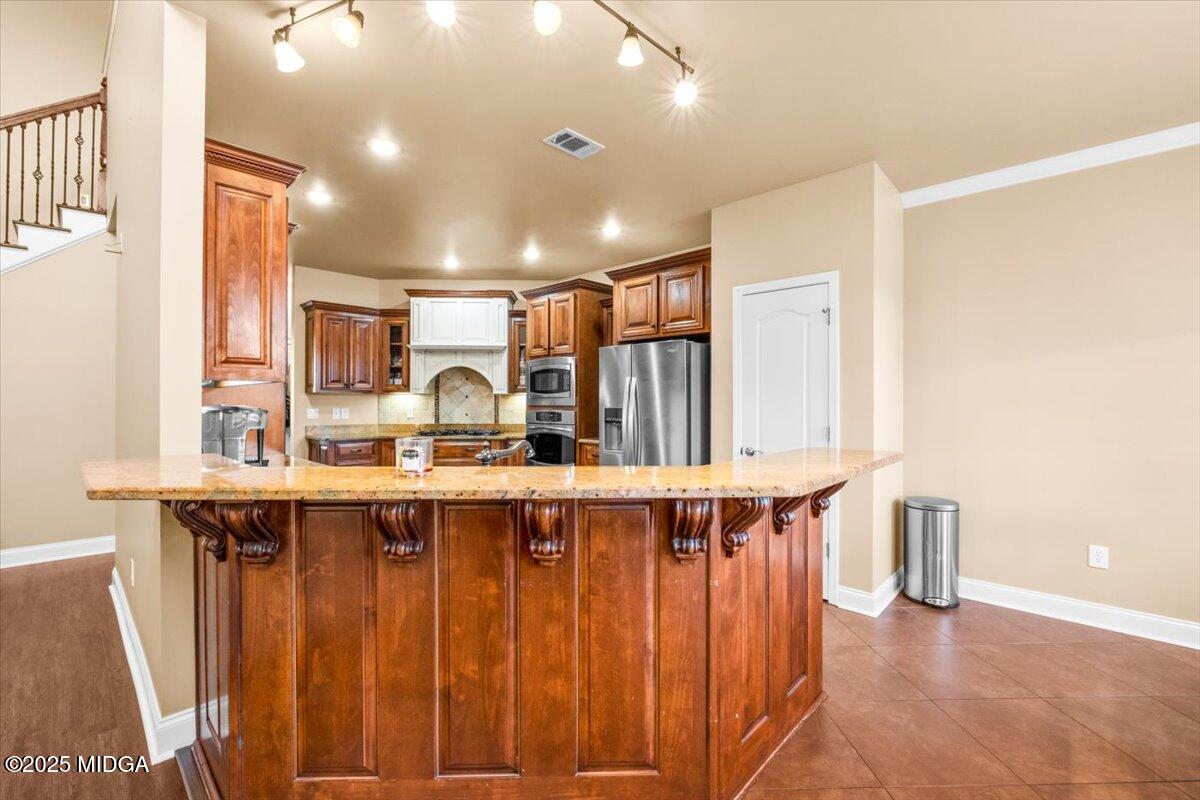 204 Cashmere Court Centerville, GA 31028 - Photo 21 of 51 a large kitchen with a table and chairs