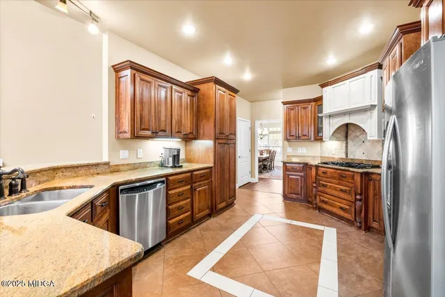 a kitchen with stainless steel appliances granite countertop a stove and a refrigerator