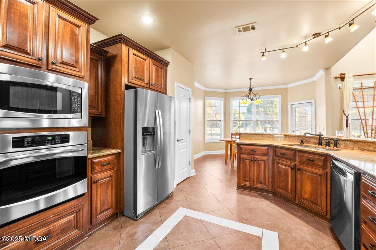204 Cashmere Court Centerville, GA 31028 - Photo 25 of 51 a large kitchen with stainless steel appliances and large cabinets