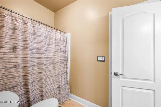 a bathroom with a sink mirror and toilet