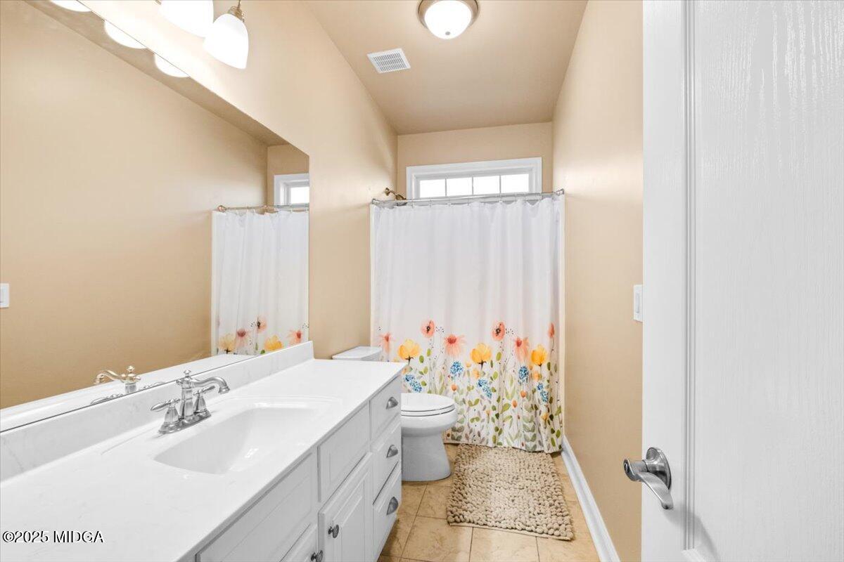 204 Cashmere Court Centerville, GA 31028 - Photo 38 of 51 a bathroom with a sink mirror and toilet