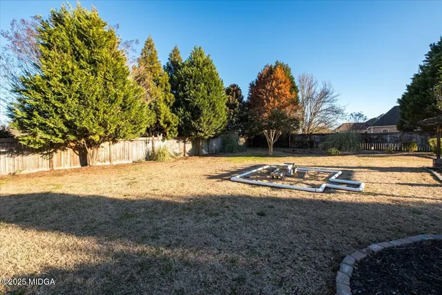 a view of a street with cars parked on the road