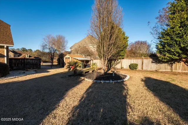 a front view of a house with a yard table and chairs