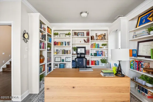 a living room with furniture and a book shelf