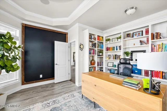 a living room with furniture and a book shelf