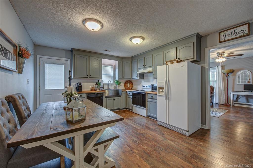 121 Pratt Street Belmont, NC 28012 - Photo 11 of 29 a kitchen with refrigerator cabinets dining table and chairs