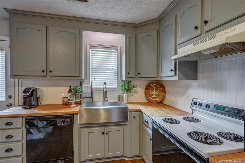 121 Pratt Street Belmont, NC 28012 - Photo 13 of 29 a kitchen with stainless steel appliances granite countertop a sink a stove and cabinets
