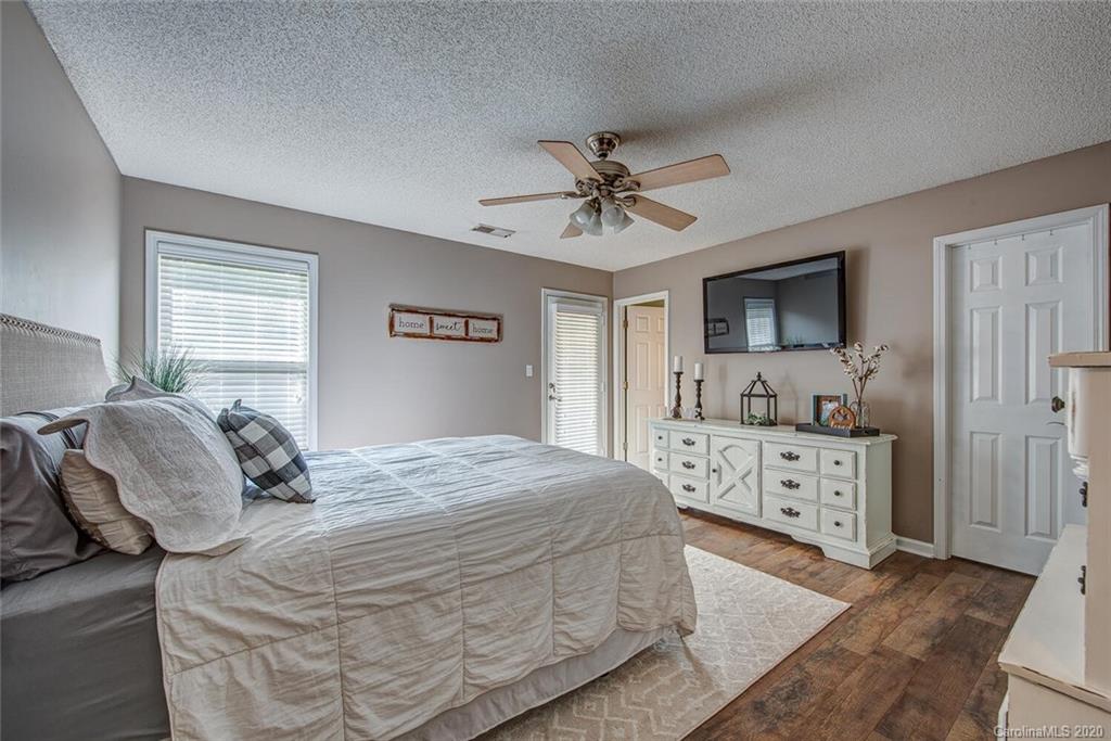 121 Pratt Street Belmont, NC 28012 - Photo 17 of 29 a bedroom with a large bed a chandelier and dresser