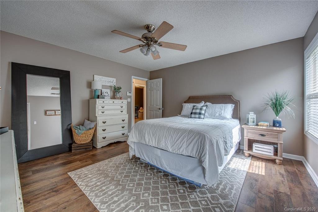 121 Pratt Street Belmont, NC 28012 - Photo 18 of 29 a bedroom with a bed and a chandelier