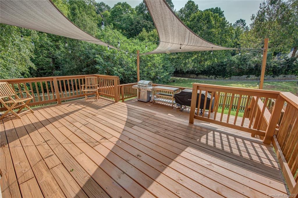 121 Pratt Street Belmont, NC 28012 - Photo 25 of 29 a balcony with wooden floor outdoor seating and yard in the back