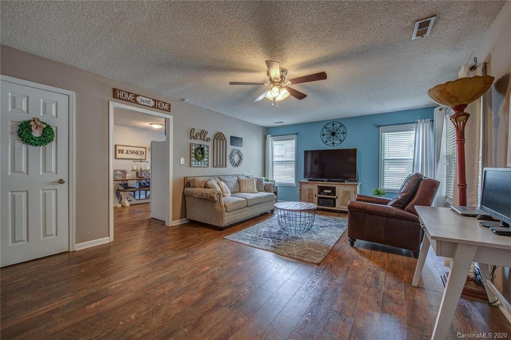 121 Pratt Street Belmont, NC 28012 - Photo 7 of 29 a living room with furniture flat screen tv and a fireplace