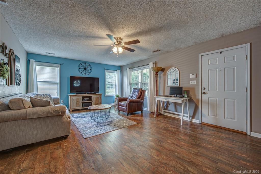 121 Pratt Street Belmont, NC 28012 - Photo 8 of 29 a living room with furniture a flat screen tv and a fireplace