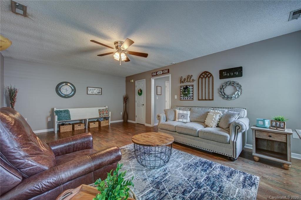 121 Pratt Street Belmont, NC 28012 - Photo 9 of 29 a living room with furniture and a chandelier
