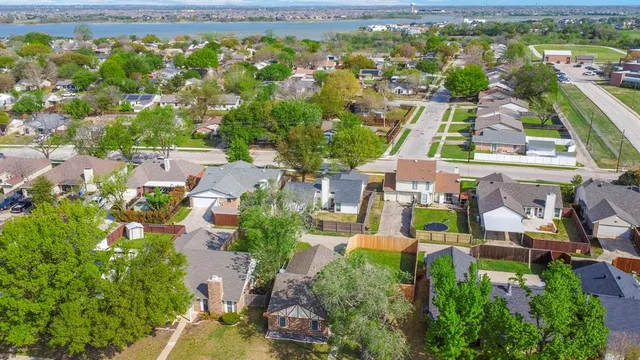 an aerial view of residential houses with outdoor space and street view