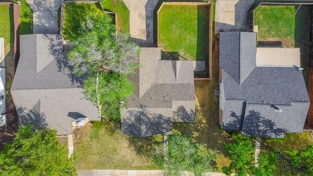 an aerial view of a house with a yard