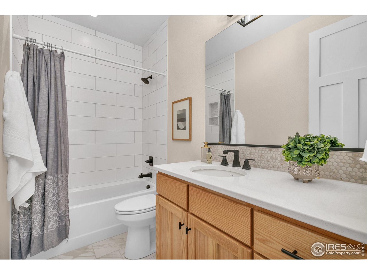 5722 West 3rd Street Greeley, CO 80634 - Photo 19 of 30 The full guest bath; all showers/tubs have full-height tile