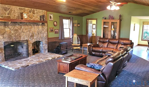 a bedroom with a bed and a flat tv screen on dresser