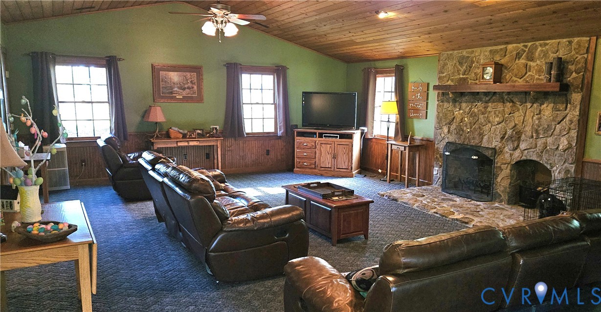 10511 Ashcake Road Ashland, VA 23005 - Photo 17 of 58 a living room with furniture a flat screen tv and a fireplace
