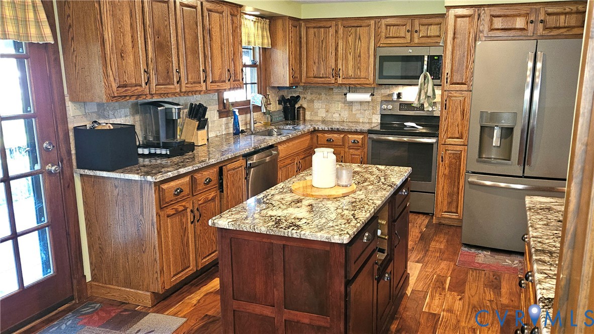 10511 Ashcake Road Ashland, VA 23005 - Photo 20 of 58 a kitchen with stainless steel appliances granite countertop a refrigerator a stove a sink and a microwave
