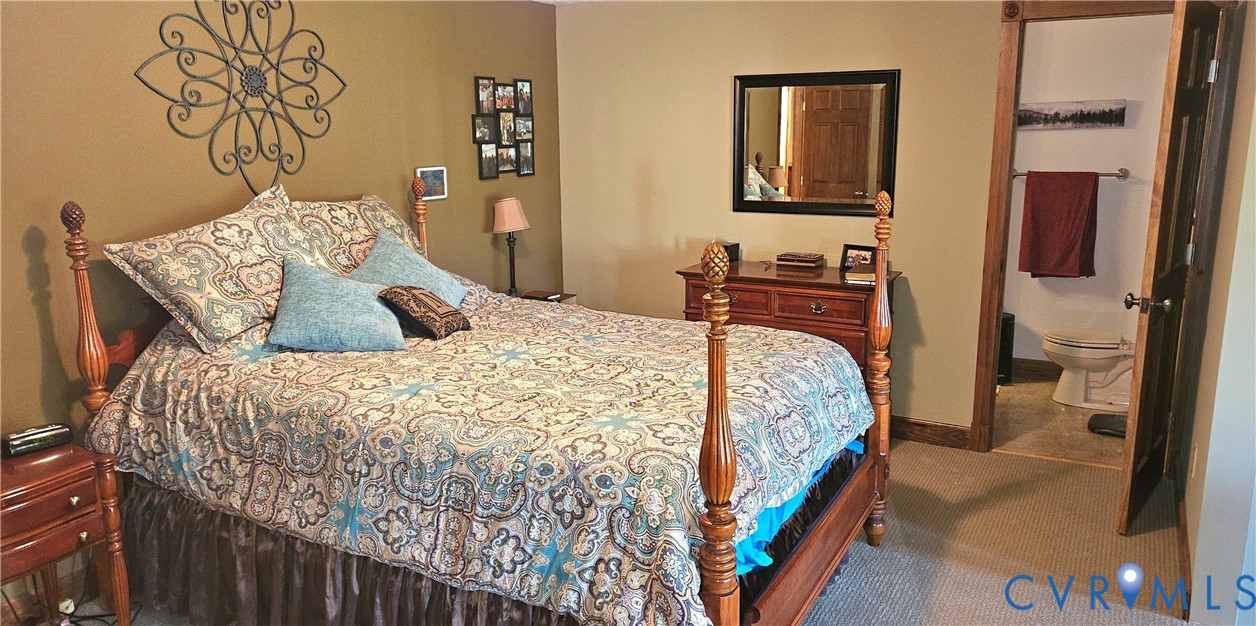 10511 Ashcake Road Ashland, VA 23005 - Photo 27 of 58 a bedroom with a bed and a flat tv screen on dresser