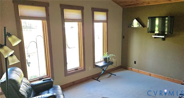a view of a porch with a table and chairs