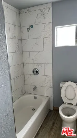 a bathroom with a sink a toilet and bathtub