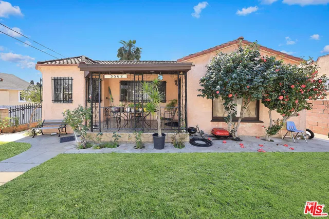 a view of a house with a backyard porch and sitting area