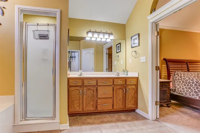 a bathroom with a double vanity sink and a mirror
