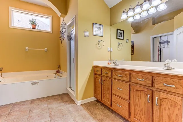 a bathroom with a tub sink and mirror
