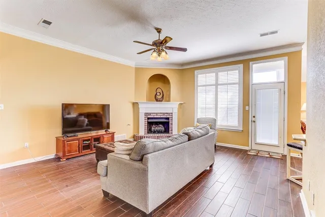 a living room with fireplace furniture and a flat screen tv